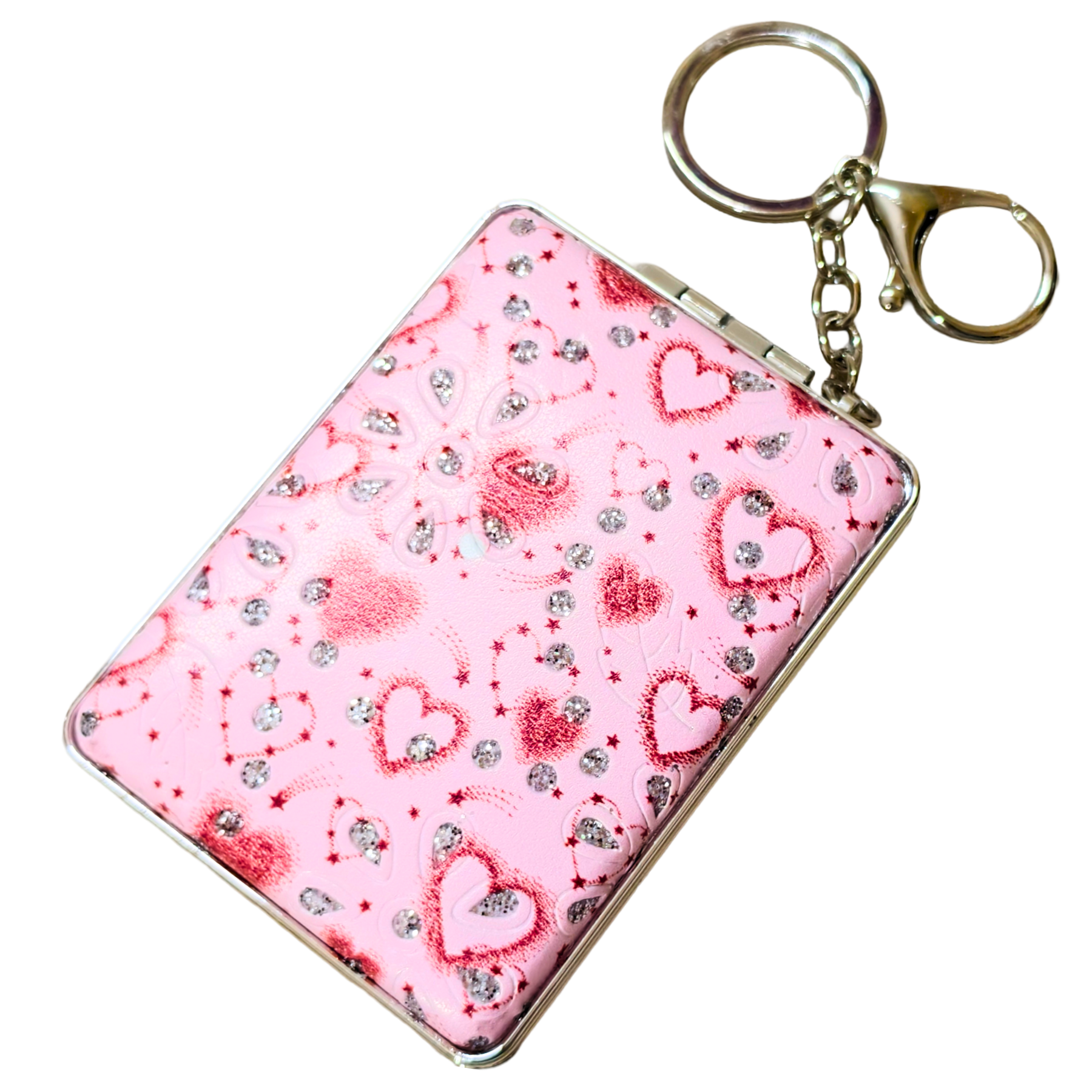 A pink rectangular card holder or compact-style case with a silver metal frame and attached gold-tone key ring and chain, decorated with red hearts and rhinestone-like sparkles on a white background.