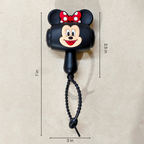 A black Mickey Mouse-shaped retractable pole or tool with a red polka-dot bow, shown on a beige background with dimension lines indicating 7 in height, 3.5 in vertical width, and 3 in horizontal width.