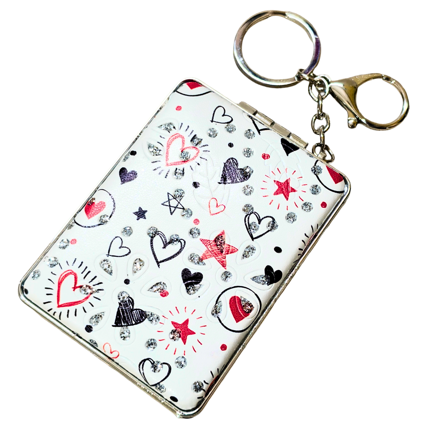 A white rectangular keychain card holder or wallet with a silver-tone metal clasp and key ring, decorated with a pattern of red, black, and silver glitter hearts and stars.
