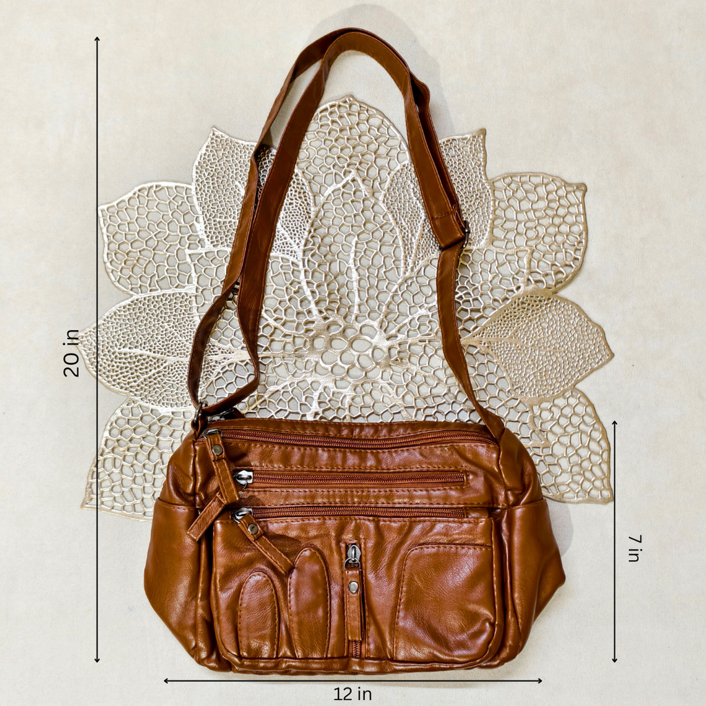 Brown leather handbag with measurements on a textured white background