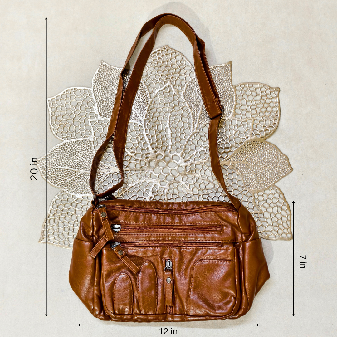 Brown leather handbag with measurements on a textured white background