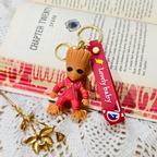 Keychain with character figure and 'Lovely baby' strap on an open book