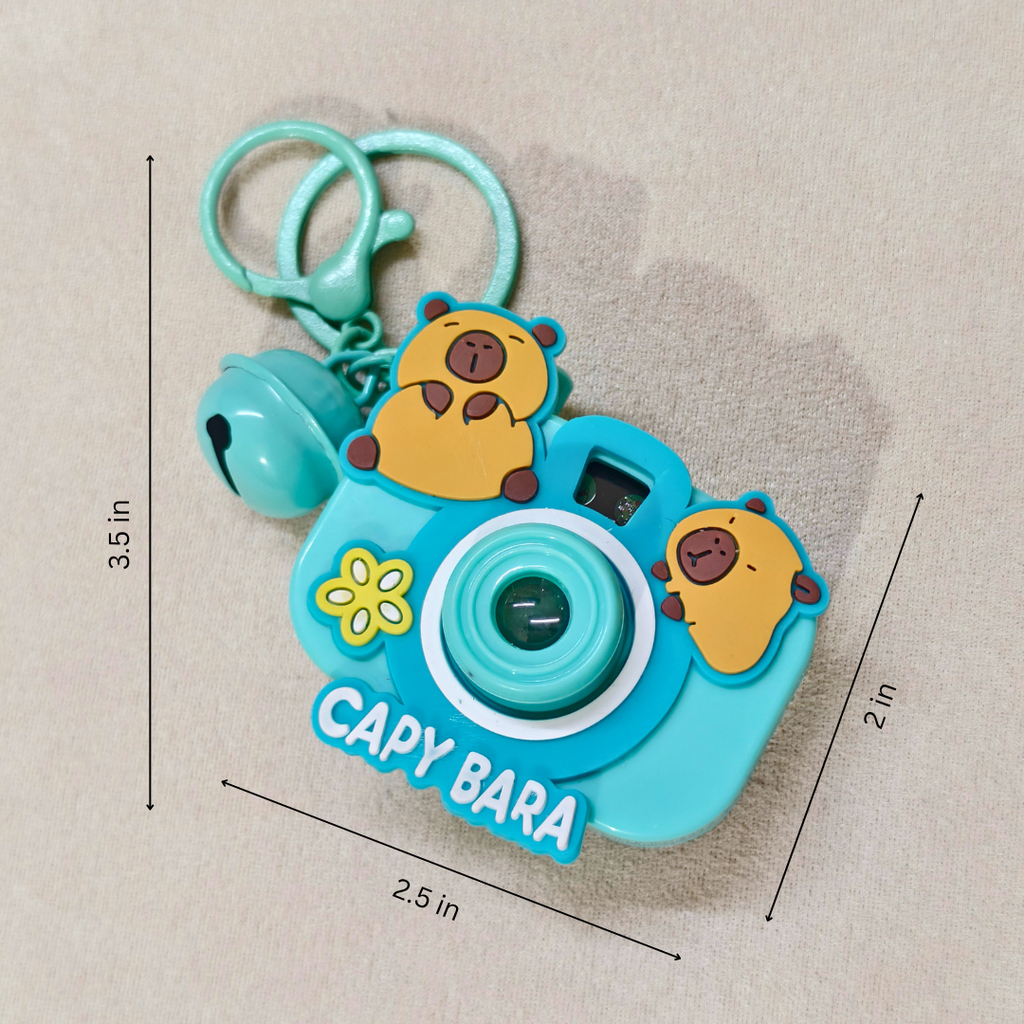 Capybara-themed toy camera with keychain on a beige background