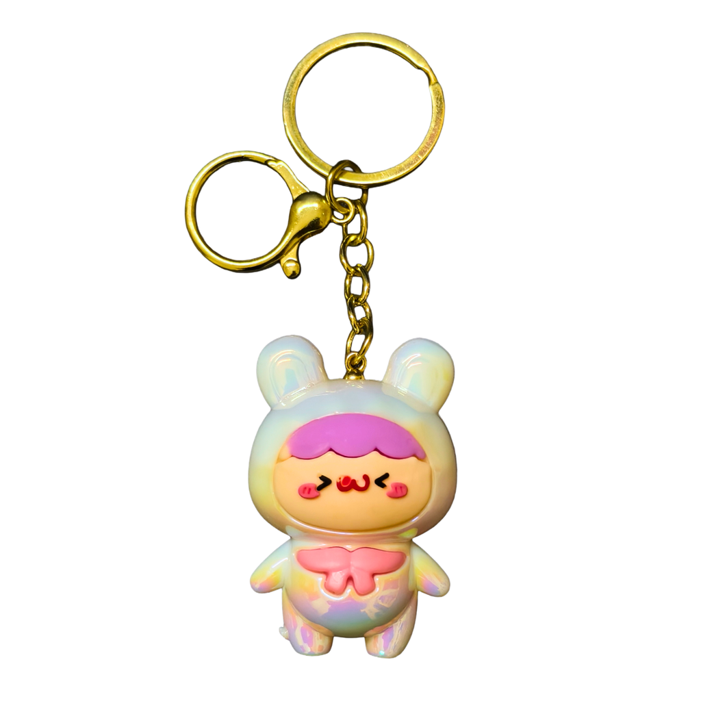 Colorful cartoon character keychain with a gold ring on a white background
