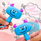 A blue monster-shaped toy hammer being held by two hands, with pink horns, a cartoon speech bubble reading 'Chu! Chu!', and a small 'BV' logo in the top left on a soft pink background.