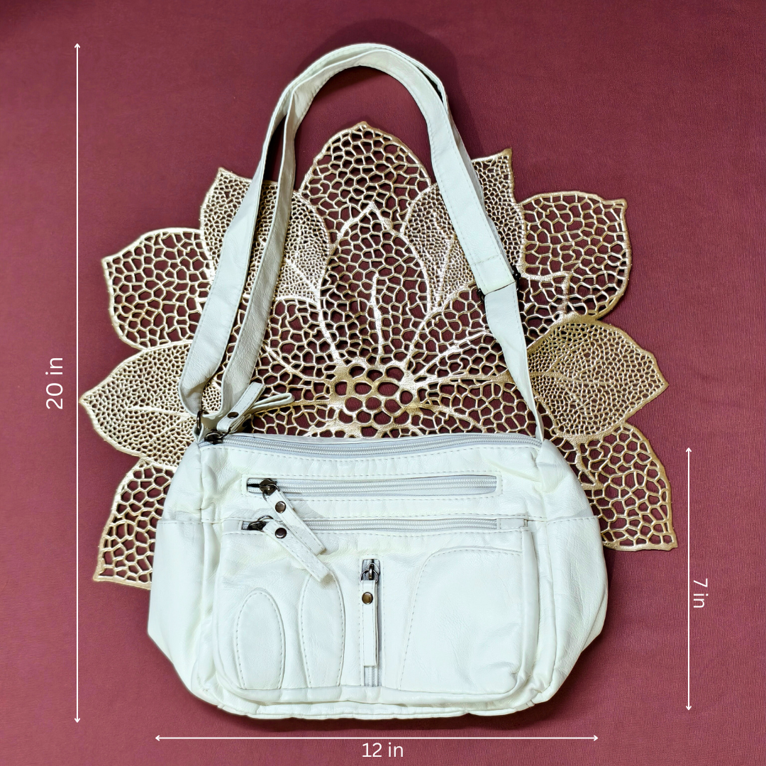 White handbag with measurements on a maroon background