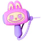 A pink and purple novelty toy shaped like a cartoon bunny face with long ears, a smiling mouth, and a coiled cord, shown on a plain white background.