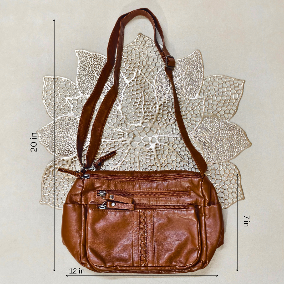 Brown leather handbag with measurements on a textured beige background