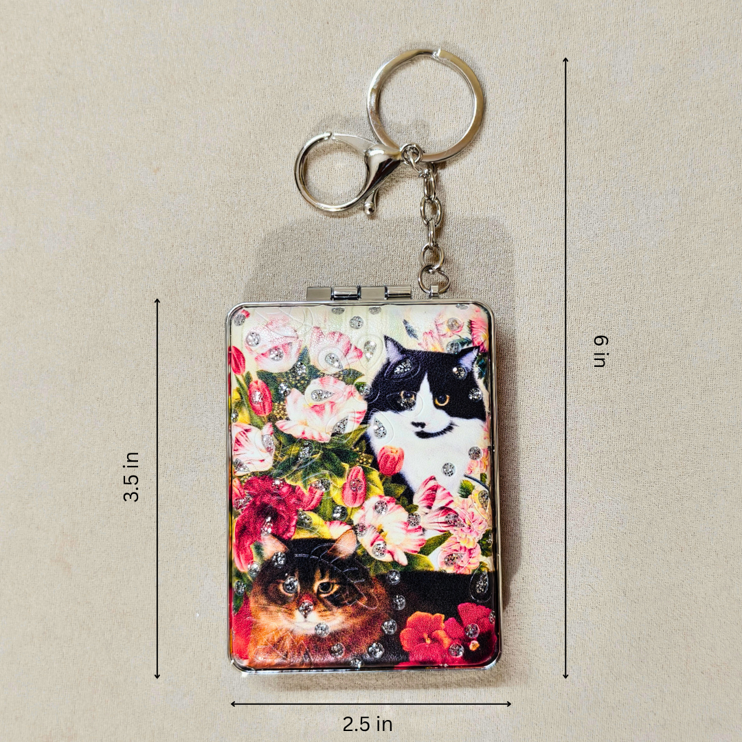 A rectangular metal keychain holder with a colorful floral and cat print, shown on a beige background with dimension lines indicating 3.5 in height, 6 in width, and 2.