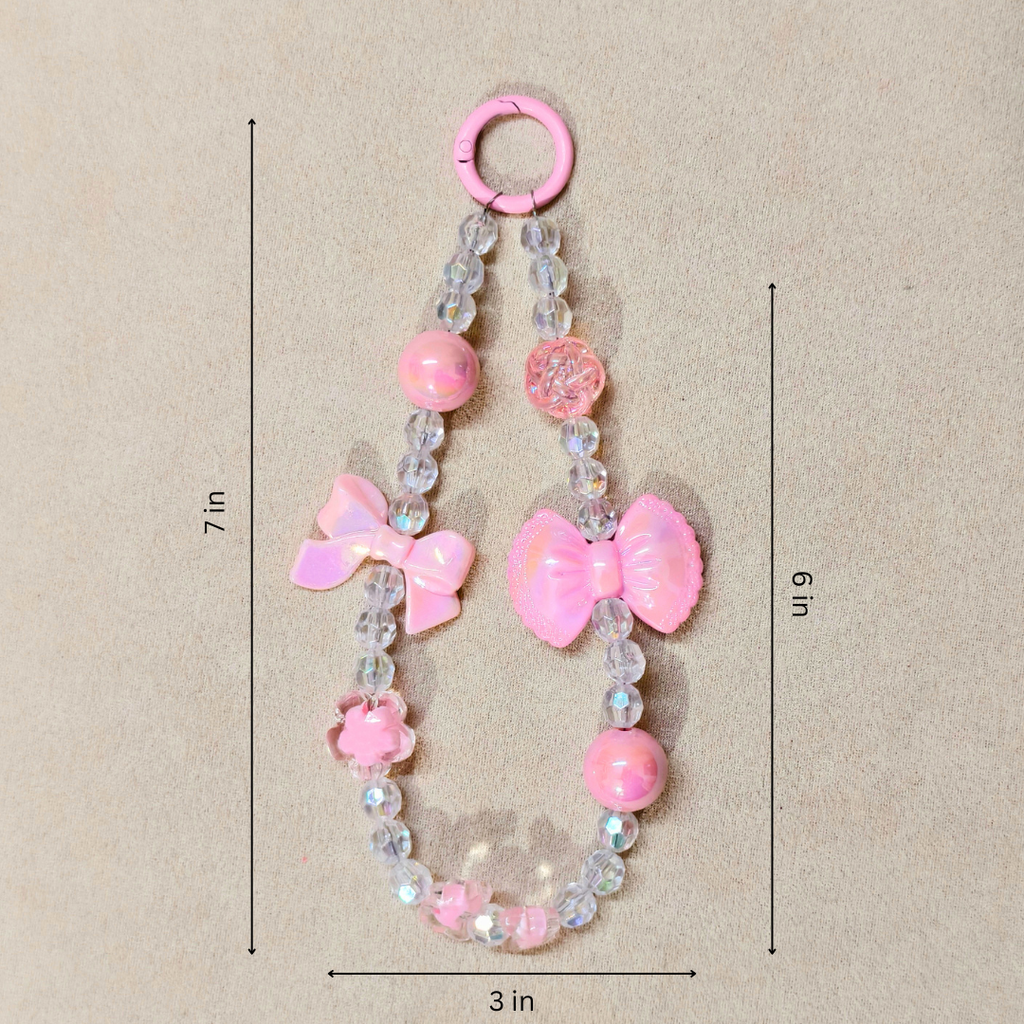 Pink Bow Charm With Measurements In Front OF Beige Background