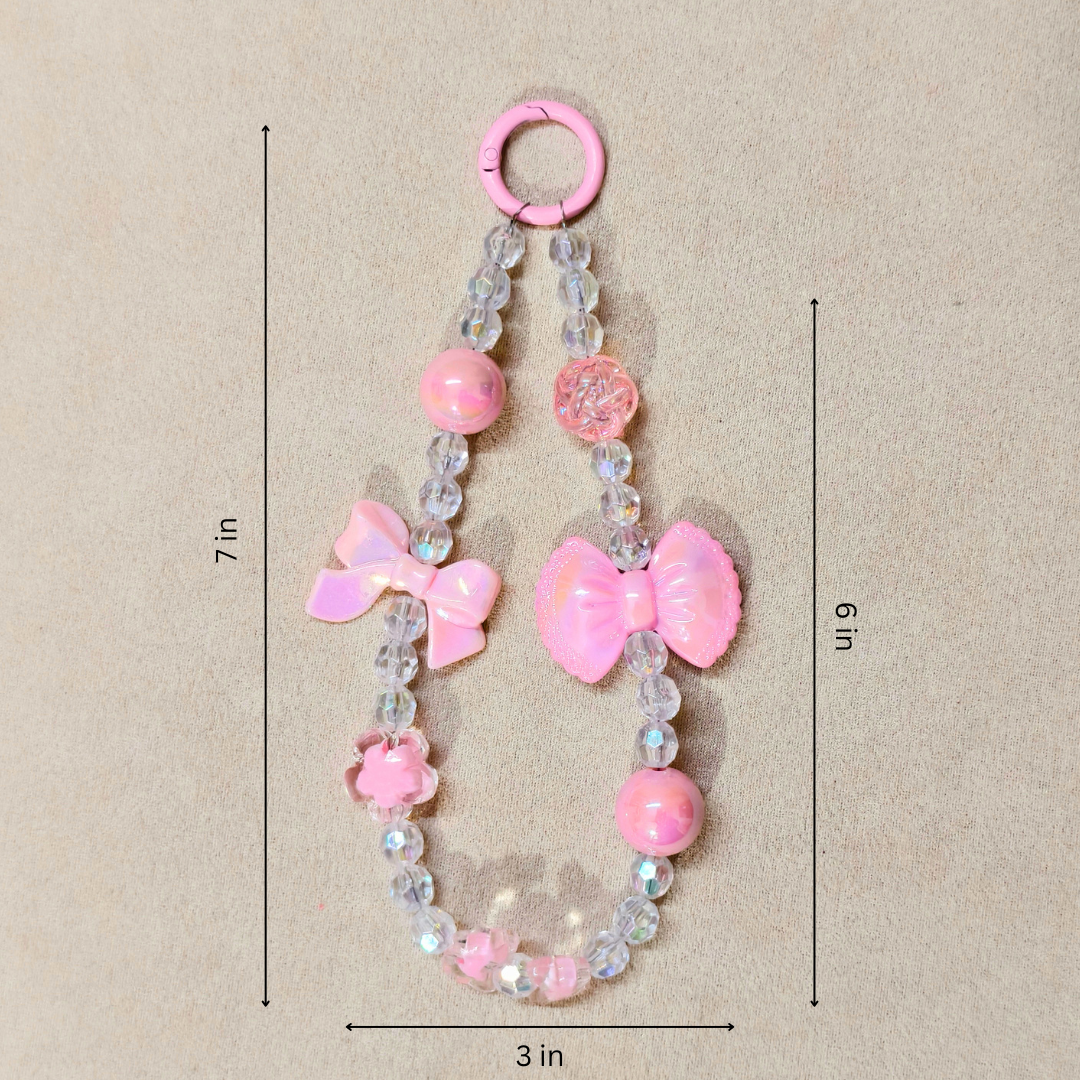 Pink Bow Charm With Measurements In Front OF Beige Background