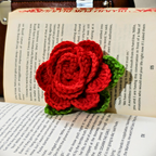 Crocheted red rose on an open book
