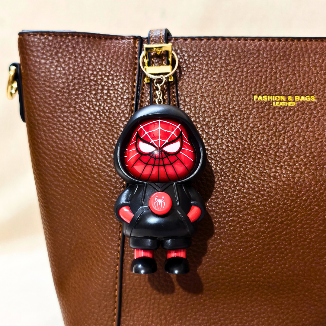 Spider-Man keychain attached to a brown leather bag with 'Fashion & Bags' branding.