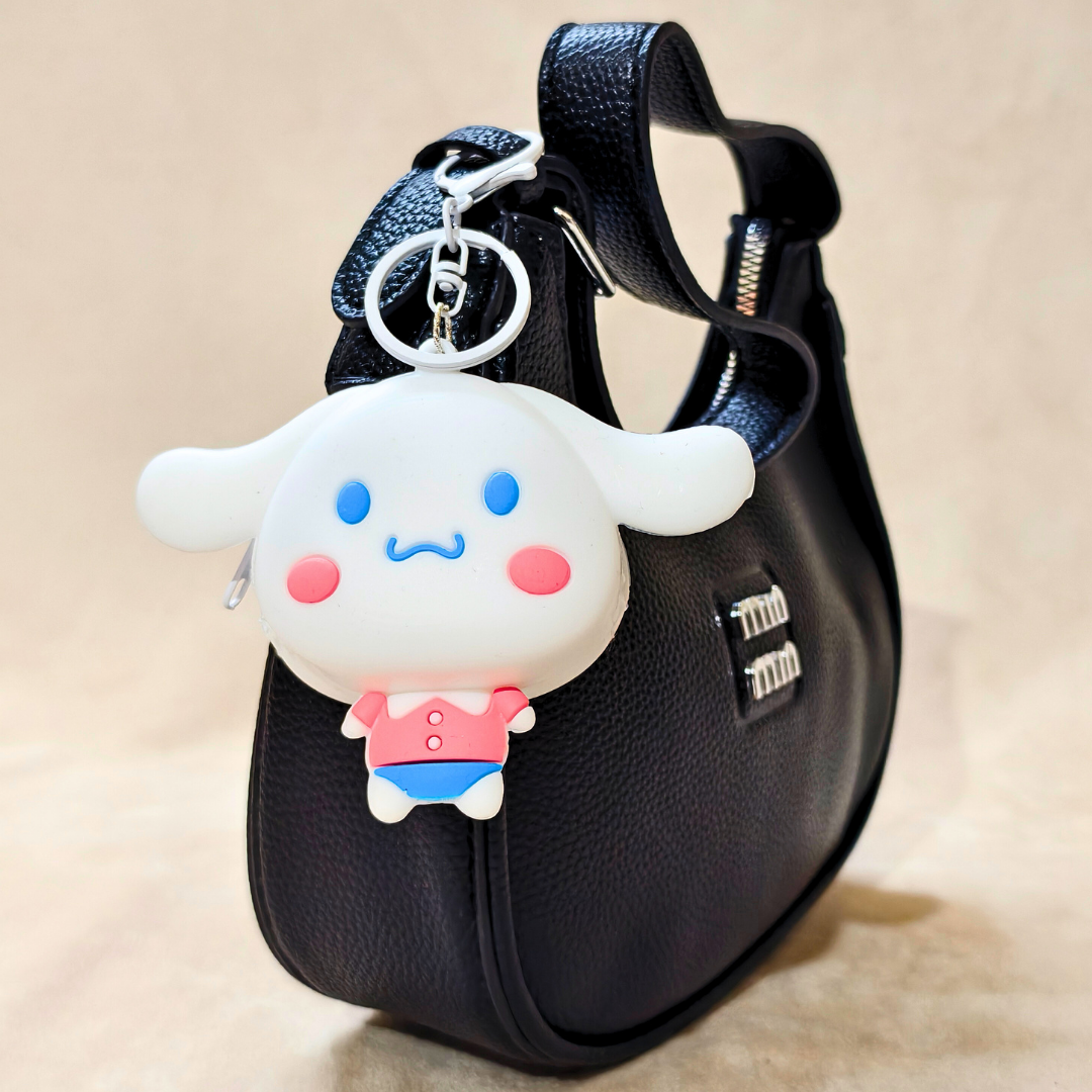 Black handbag with a cute character keychain on a beige background