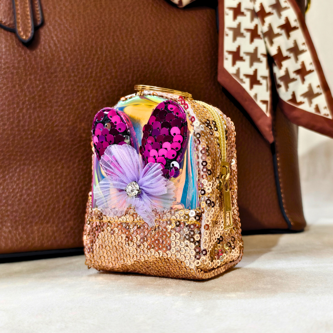 Decorative item with sequins and a flower on a neutral background