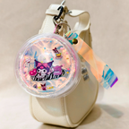 Keychain with cartoon character design on a beige background