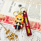 Keychain with 'Demon Slayer' character on a book page