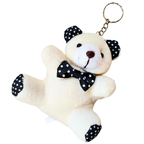 A plush teddy bear keychain in cream-colored fabric, decorated with a black and white polka dot bow tie, matching polka dot ear bands, and polka dot feet, attached to a gold metal key ring.
