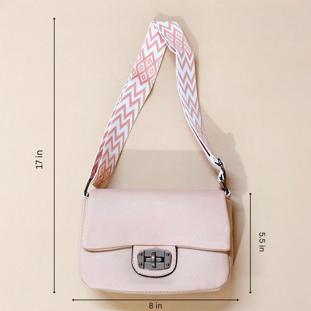 Pink handbag with a patterned strap on a beige background, showing measurements.