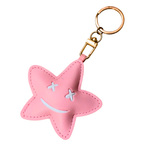 Pink star-shaped keychain with a smiley face on a white background