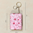 A rectangular compact-style keychain with a pink heart pattern, shown with metal key rings and clasp. Black dimension lines and text indicate measurements of 3.