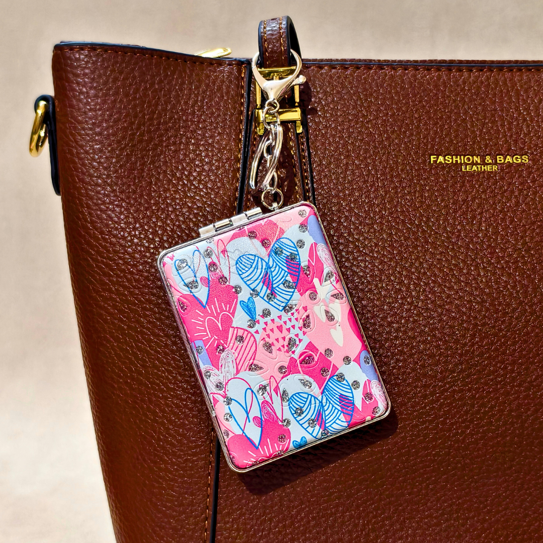 Rectangle Hearts Pink Pocket Mirror Attached With Purse As  Bag Charm On  Beige Background.