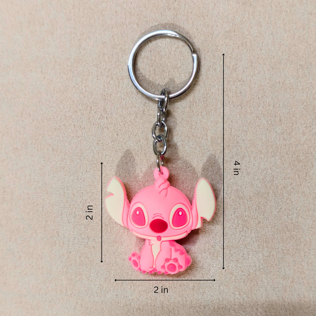 Pink cartoon character keychain with measurements on a beige background