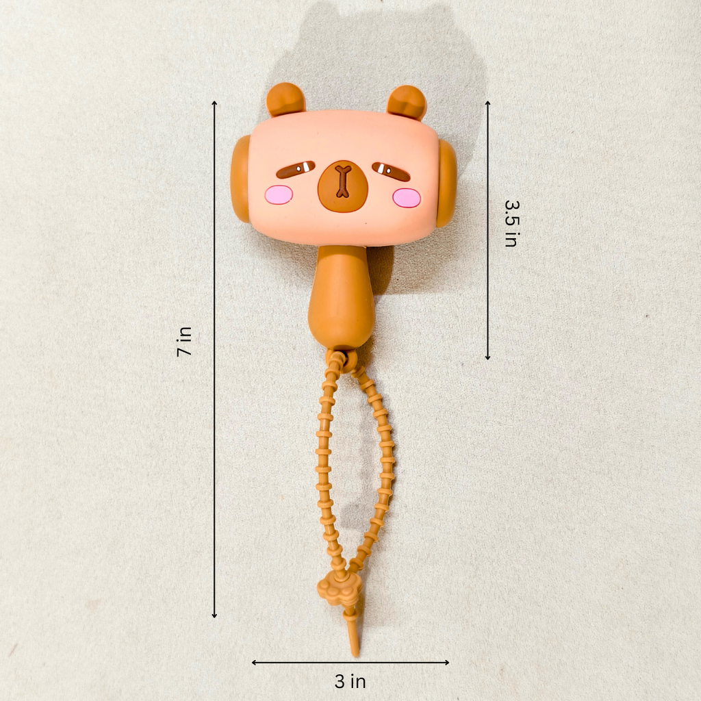 Cute animal-shaped toy with measurements on a light background