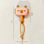 Cute animal-shaped toy with measurements on a light background