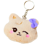 A cute plush keychain shaped like a winking cat face in light beige faux fur, featuring embroidered details, pink cheeks, a purple bow, and a gold metal key ring.