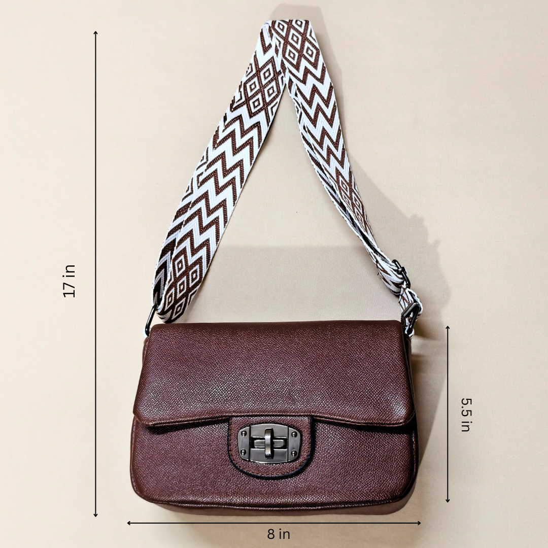 Brown shoulder bag with a patterned strap on a beige background, showing measurements.