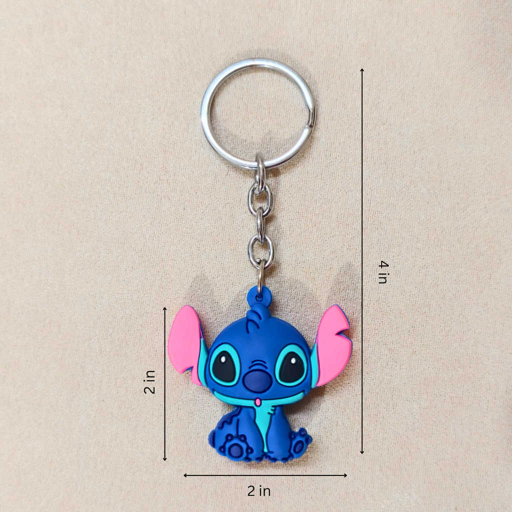 Blue cartoon character keychain with pink accents on a beige background