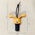 Cartoon character keychain with measurements on a beige background