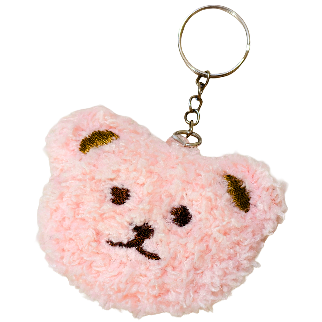 A pink fuzzy teddy bear head keychain with embroidered brown facial features and gold ear accents, attached to a silver metal key ring on a plain white background.