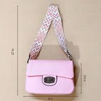 Pink shoulder bag with a patterned strap on a beige background, showing measurements.