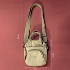 Beige shoulder bag with measurements on a red background