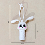 White bunny-shaped toy with measurements on a beige background