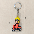 Keychain of a character riding a motorcycle with measurements on a beige background