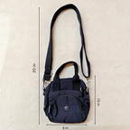 Black crossbody bag with measurements on a beige background