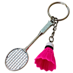  silver metal badminton racket keychain with a small pink and white plastic shuttlecock attached, against a plain white background.