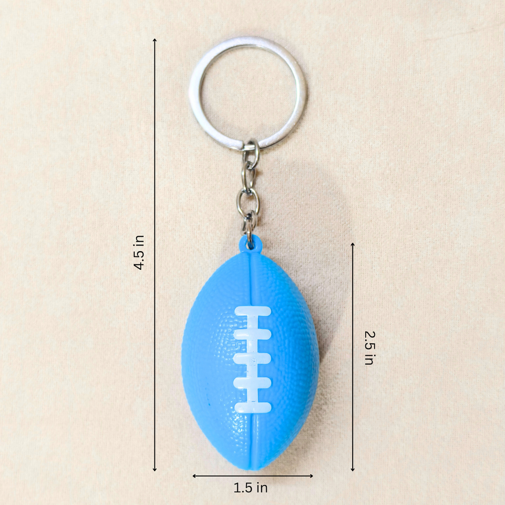 A blue football-shaped keychain with a silver metal key ring and chain, shown on a beige background with dimension lines and text indicating measurements of 4.5 in, 2.