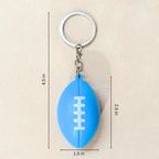 A blue football-shaped keychain with a silver metal key ring and chain, shown on a beige background with dimension lines and text indicating measurements of 4.5 in, 2.