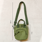 Green crossbody bag with measurements on a beige background