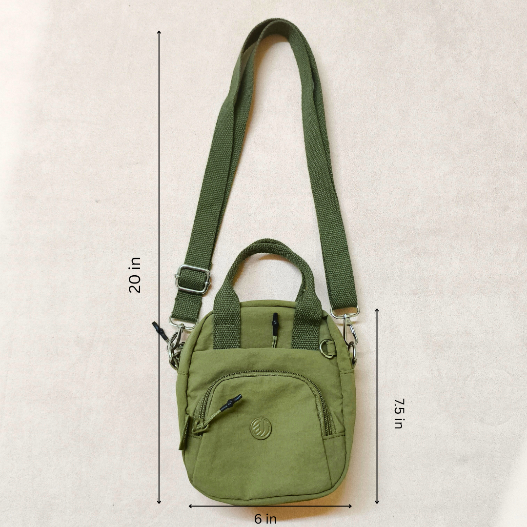 Green crossbody bag with measurements on a beige background