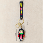 Keychain with character design and measurement details on a beige background