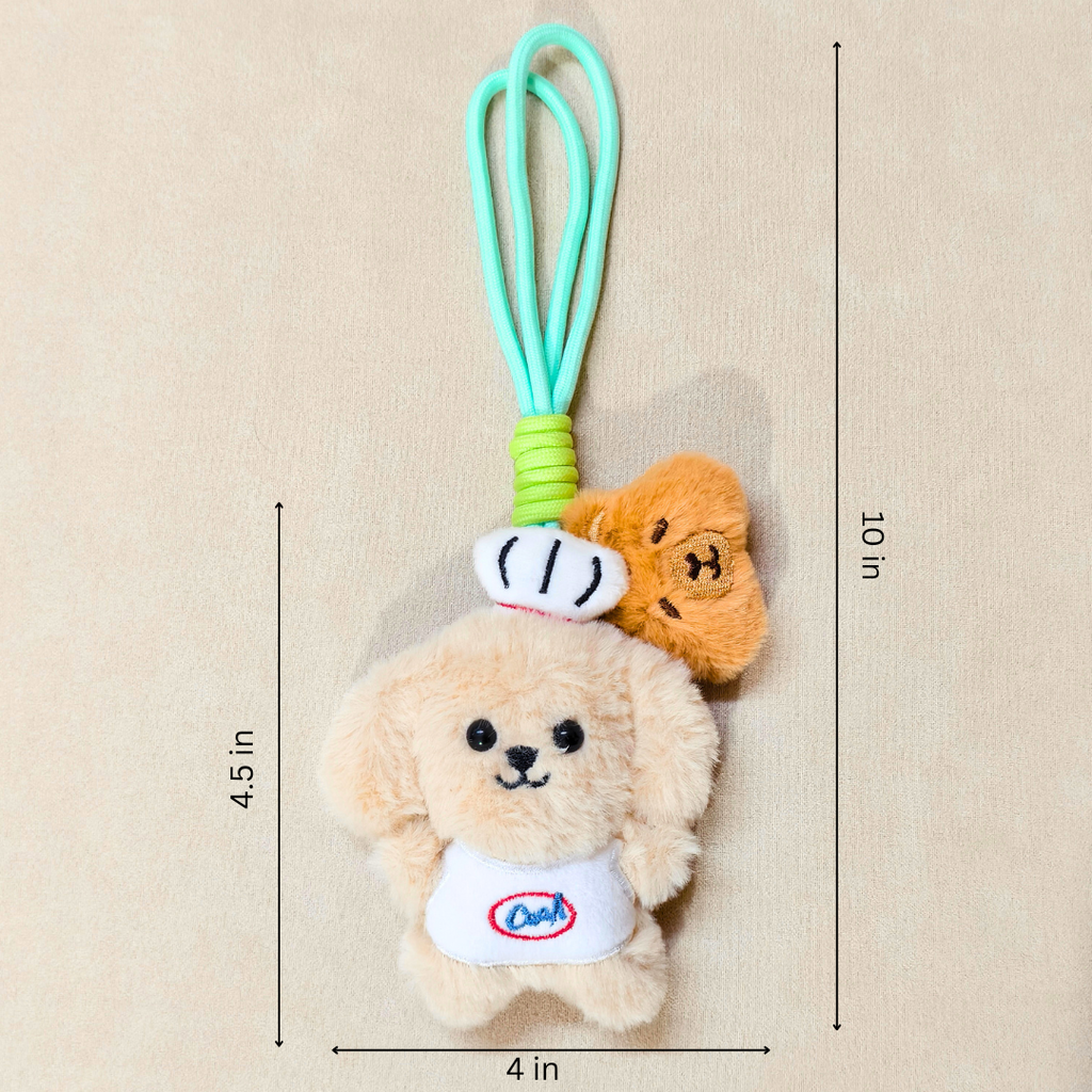 A plush dog keychain charm with a mint green loop strap, featuring a beige fluffy dog wearing a white chef hat and white shirt with a blue and red logo, with a small orange dog peeking out from behind. Black dimension lines and text indicate measurements of 4.