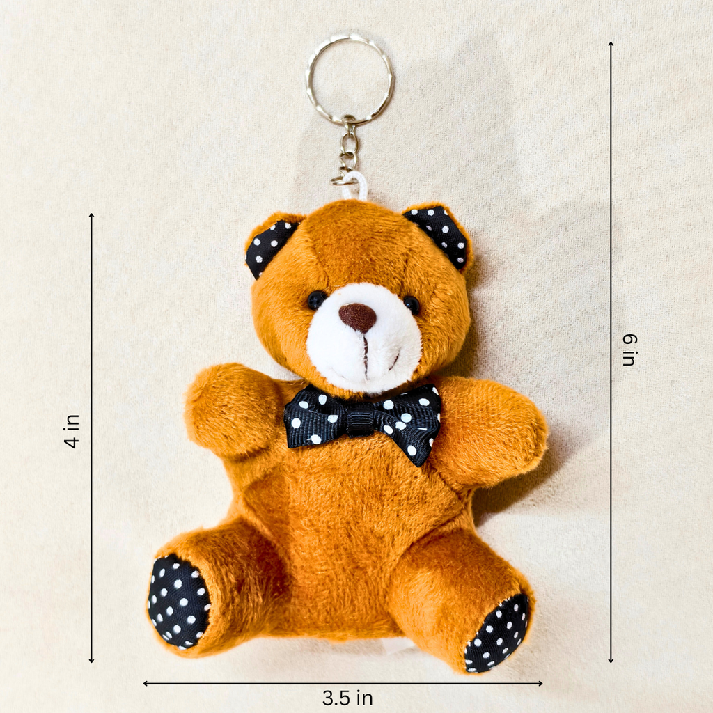 A plush teddy bear keychain in brown with a white snout, black polka-dot ears and bow tie, and black polka-dot paw pads, shown on a light beige background with dimension lines indicating 3.5 in width, 4 in height, and 6 in overall size.