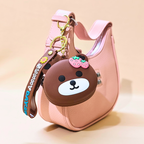 Pink handbag with a bear-shaped keychain on a beige background