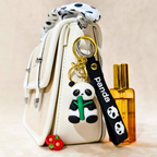 Panda keychain with a small bag and bottle on a beige background