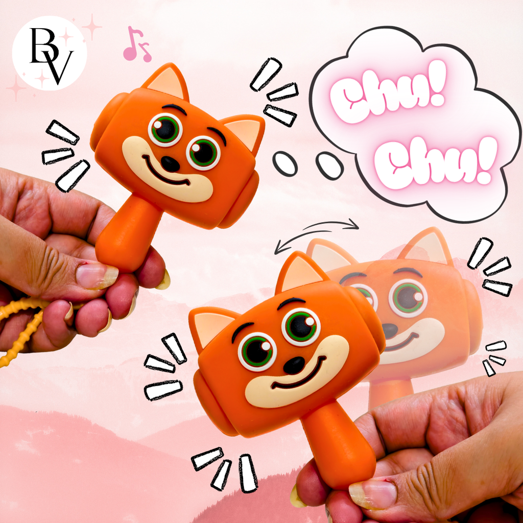 An orange cat-shaped hand toy being held by two hands, with cartoon-style sound effects and a thought bubble reading 'Chu! Chu!'. The background is a soft pink gradient with decorative doodles.